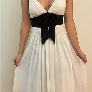 White slip on dress with black bow and straps